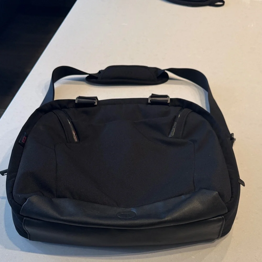 Tumi Black Messenger Bag excellent condition stay organized.